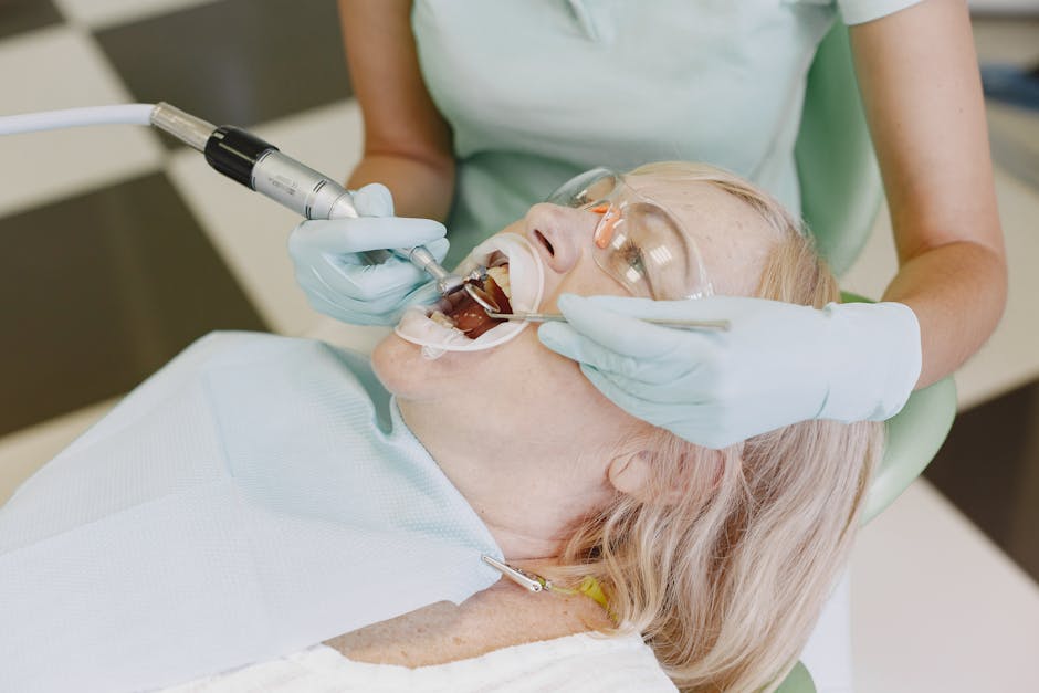 A dentist performs dental treatment on a senior woman patient. Healthcare in a clinical setting.