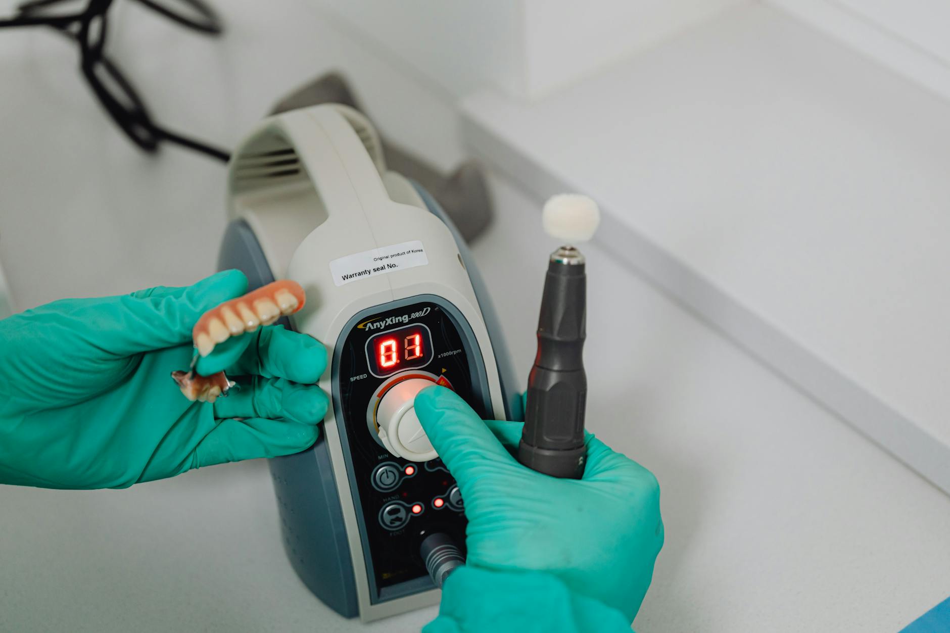 Master ceramist crafting custom porcelain veneers in laboratory