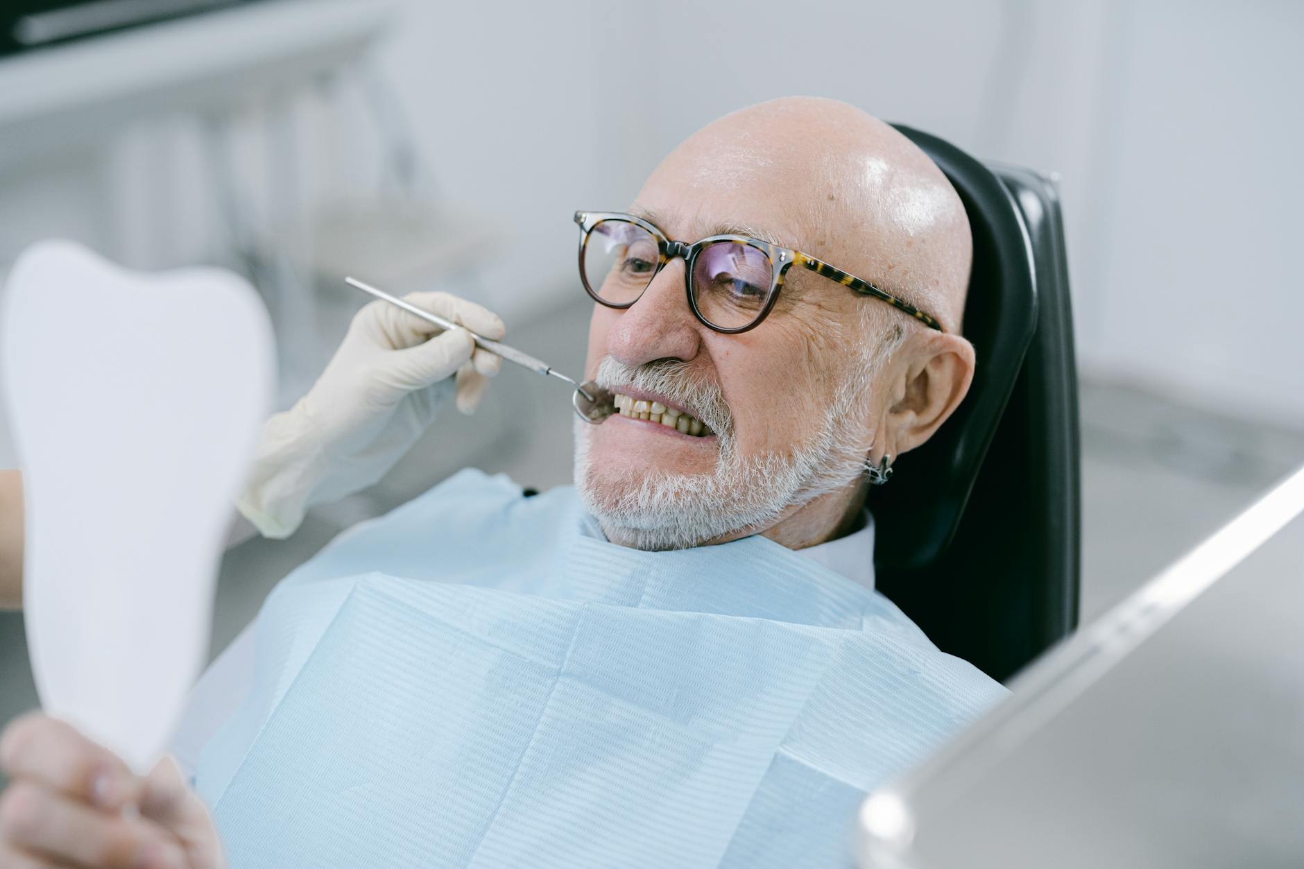 Senior patient smiling with implant-supported dentures